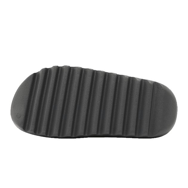 Adidas Yeezy Slide Granite - Moderne grauwensneakerset tegen groene achtergrond