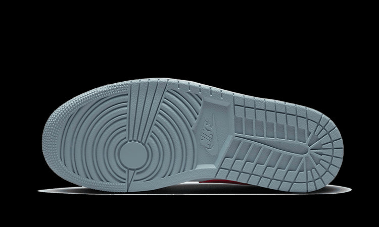 Een paar stijlvolle Air Jordan 1 Low sneakers in de kleur "Blue Whisper". De onderkant van de schoen heeft een gestructureerd en robuust design, wat de schoen een premium look geeft. Deze sneakers zijn een moderne klassieker die perfect passen bij elke casual outfit.