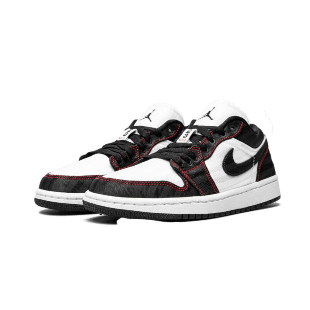Klassieke Air Jordan 1 Low SE Utility sneakers van Nike. Zwart-witte kleurblokken met het iconische Jumpman-logo. Deze multifunctionele sneakers bieden comfort en stijl voor elke outfit.