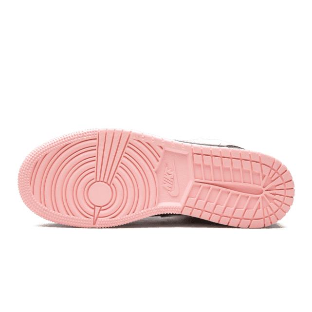 Elegante Nike Air Jordan 1 Mid Arctic Pink Black sneakers met roze zool op een groene achtergrond