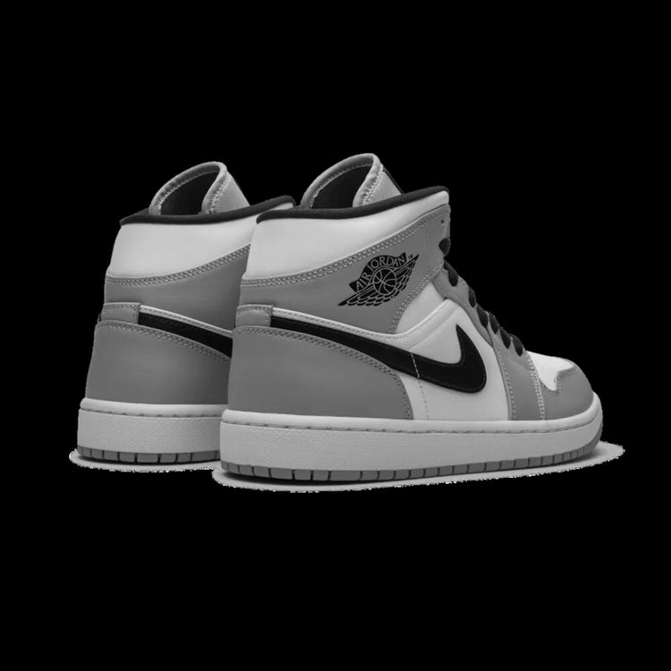 Chique Nike Air Jordan 1 Mid Light Smoke Grey sneakers op effen groene achtergrond