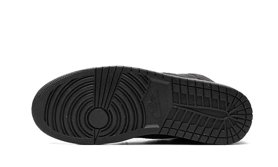 Grijsrode Nike Air Jordan 1 Mid SE-sneakers op een groene achtergrond