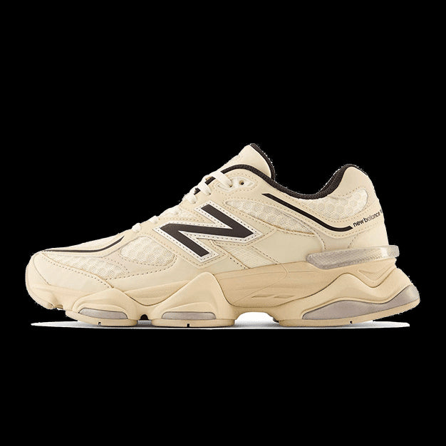 New Balance 9060 Cream Black sneakers on a plain green background