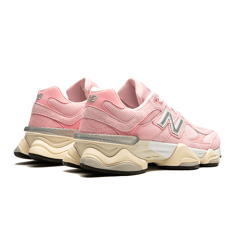 Stylish New Balance 9060 sneakers in a beautiful crystal pink colorway, featured against a vibrant green background. These trendy athletic shoes showcase the brand's signature logo and chunky, comfortable silhouette, perfect for upgrading your casual wardrobe.