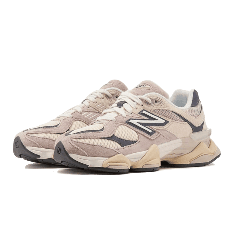 Beige and gray New Balance 9060 Moonrock Linen sneakers displayed on a plain green background. The shoes feature the iconic New Balance logo and have a retro, chunky style design.