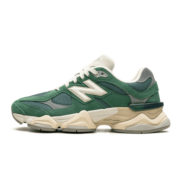 Green New Balance 9060 sneakers with cream accents on a plain green background