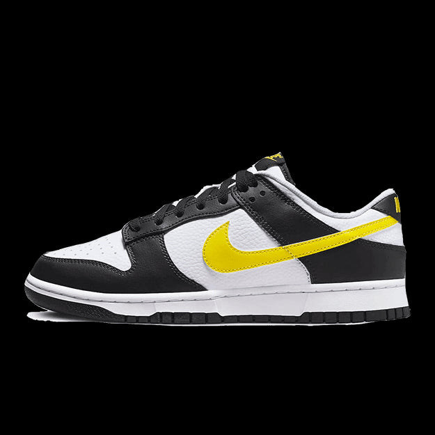 Kleurrijke Nike Dunk Low sneakers in zwart, wit en geel. Dit paar sneakers heeft een klassiek ontwerp met een eenvoudige, minimalistische stijl. De opvallende gele Swoosh op de zijkant zorgt voor een pops of kleur die de sneaker extra accent geeft.