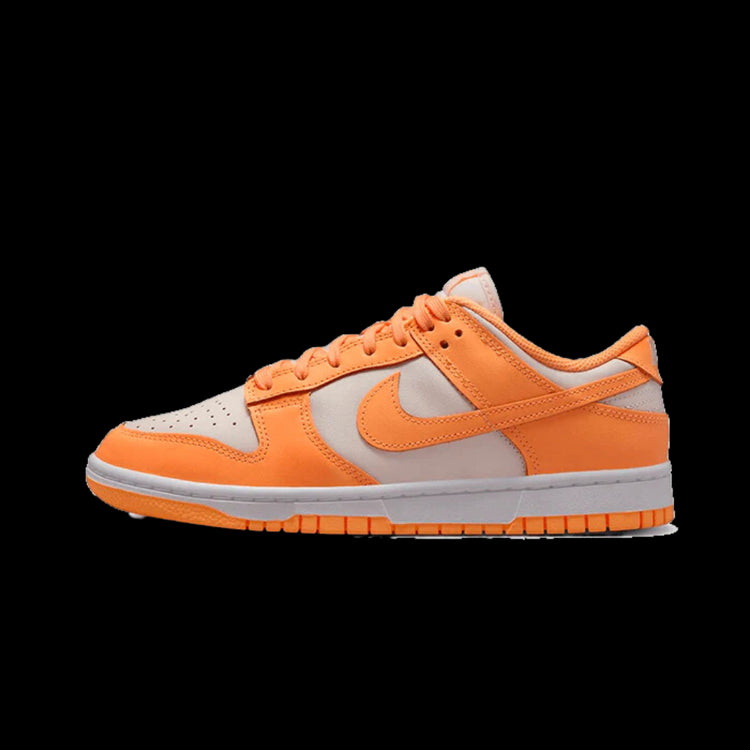 Oranje Nike Dunk Low Peach Cream sneakers getoond op een zwarte achtergrond. De sneakers hebben een frisse, zomerse kleur met witte en oranje panelen. Een klassiek sportief silhouet met een vlakke zool voor comfort.