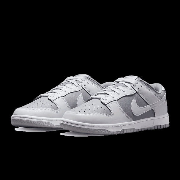 Grijze Nike Dunk Low Retro sneakers - klassieke sneaker met lichtgrijs suède bovenwerk en Nike Swoosh-logo.